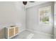 Bedroom with a ceiling fan, cabinet, and a window at 13864 Posada St, Venice, FL 34293