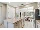 Contemporary kitchen with a spacious island, ample cabinetry, and convenient access to the dining area at 13864 Posada St, Venice, FL 34293