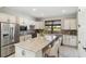 Modern kitchen with stainless steel appliances, quartz countertops, and a stylish backsplash at 13864 Posada St, Venice, FL 34293