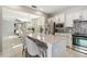 Well-designed kitchen overlooking the living area, featuring an island with bar seating and modern appliances at 13864 Posada St, Venice, FL 34293