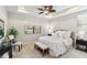 Serene main bedroom featuring a tray ceiling, neutral color palette, and large window overlooking the outdoors at 13864 Posada St, Venice, FL 34293