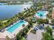 Stunning aerial view of community pools and lakefront homes in a beautiful landscaped neighborhood at 13864 Posada St, Venice, FL 34293