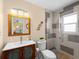 Bathroom with modern fixtures, wooden vanity and walk-in shower with patterned tile at 1423 Avenida Del Circo # 1C, Venice, FL 34285