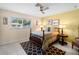Bedroom with decorative walls, ceiling fan, neutral color scheme, and patterned rug at 1423 Avenida Del Circo # 1C, Venice, FL 34285