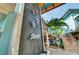 Coastal restaurant exterior with outdoor dining, stone waterfall feature, and tropical landscaping at 1423 Avenida Del Circo # 1C, Venice, FL 34285