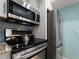 Modern kitchen appliances include an oven, microwave, and stainless steel refrigerator at 1423 Avenida Del Circo # 1C, Venice, FL 34285