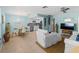 Inviting living room with comfortable seating, modern ceiling fan, and seamless flow to the kitchen and dining area at 1423 Avenida Del Circo # 1C, Venice, FL 34285
