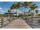 Charming beachside restaurant entrance with rustic wooden walkway and tropical ambiance at 1423 Avenida Del Circo # 1C, Venice, FL 34285