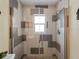 Walk-in shower with mosaic patterned tile and window at 1423 Avenida Del Circo # 1C, Venice, FL 34285