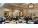 An elegant dining room features tables set with blue napkins and tableware, ready for a delightful meal at 256 Royal Oak Way, Venice, FL 34292