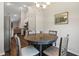 A dining room with a round table and chairs, with stainless steel refrigerator and view to the living room at 2949 Jaylene Rd, North Port, FL 34288
