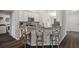 Kitchen bar top with three stools, with stainless steel microwave and granite countertops at 2949 Jaylene Rd, North Port, FL 34288