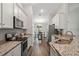 Kitchen featuring stainless steel appliances, white cabinets, granite countertops and dark wood flooring at 2949 Jaylene Rd, North Port, FL 34288