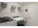 Laundry room with Whirlpool washer and dryer, utility sink and shelves at 2949 Jaylene Rd, North Port, FL 34288