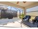 Screened patio area featuring comfortable seating, outdoor decor, and a view of the backyard at 2949 Jaylene Rd, North Port, FL 34288
