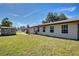 View of the back of the home featuring a lush lawn at 3187 Galiot Rd, Venice, FL 34293