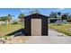 Exterior shot of shed with concrete flooring and double doors at 3187 Galiot Rd, Venice, FL 34293