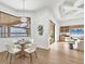 Cozy dining area with serene lake views, perfect for enjoying meals in a bright and relaxing setting at 400 Maraviya Blvd, Nokomis, FL 34275