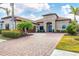 Stunning home showcasing beautiful landscaping, paver driveway, and charming architectural details at 400 Maraviya Blvd, Nokomis, FL 34275
