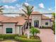 Stunning waterfront home featuring a terracotta roof and elegant double door entry at 400 Maraviya Blvd, Nokomis, FL 34275