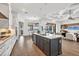 Gourmet kitchen flows to living area and offers a central island, stainless appliances, and beautiful tiled flooring at 400 Maraviya Blvd, Nokomis, FL 34275