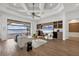 Bright living room boasts modern decor, built-in entertainment center, and seamless access to the outdoor pool area at 400 Maraviya Blvd, Nokomis, FL 34275