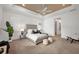 A bright main bedroom with a tray ceiling, recessed lights, a large plant and stylish furnishings at 400 Maraviya Blvd, Nokomis, FL 34275
