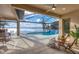 Stunning screened-in pool area featuring a waterfall and serene lake views, perfect for outdoor relaxation and entertainment at 400 Maraviya Blvd, Nokomis, FL 34275