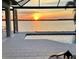 Waterfront sunset view from a pool deck, showcasing a serene and picturesque outdoor living space at 400 Maraviya Blvd, Nokomis, FL 34275