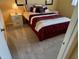 Comfortable bedroom featuring wall art, a nightstand, and carpet at 408 Cerromar S Cir # 132, Venice, FL 34293