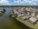 Aerial view of a lakeside community showcasing well-maintained homes and beautiful landscaping at 651 Lakescene Dr, Venice, FL 34293