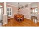 Traditional dining room with hardwood floors, chandelier, and view into the kitchen at 651 Lakescene Dr, Venice, FL 34293