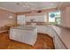 Bright kitchen featuring hardwood floors, center island, and white cabinetry at 651 Lakescene Dr, Venice, FL 34293