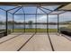 Screened lanai offering panoramic lake views and ample space for outdoor seating at 651 Lakescene Dr, Venice, FL 34293