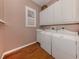 Functional laundry room featuring ample cabinet space, a utility sink, and modern washer and dryer at 651 Lakescene Dr, Venice, FL 34293