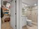 Clean bathroom with glass enclosed shower, tile accents, white cabinets, and a walk-in closet at 840 The Esplanade N # 104, Venice, FL 34285