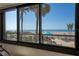Breathtaking beach views through large windows highlight outdoor seating and sandy shores at 840 The Esplanade N # 104, Venice, FL 34285