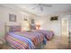 Bright bedroom with twin beds featuring striped bedding, playful decor, and tile floors at 840 The Esplanade N # 104, Venice, FL 34285