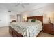 Charming bedroom with wooden furniture, decorative bedding, and ample natural light at 840 The Esplanade N # 104, Venice, FL 34285