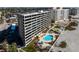 Beautiful condo with a community pool and landscaping, adjacent to the beach, palm trees, and lounge area at 840 The Esplanade N # 104, Venice, FL 34285