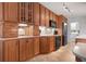 Traditional kitchen boasts wood cabinets, tile floor, black appliances, and plentiful counter space at 840 The Esplanade N # 104, Venice, FL 34285