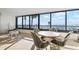 Lanai with panoramic ocean views, tile flooring, seating, and expansive windows at 840 The Esplanade N # 104, Venice, FL 34285