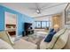 Airy living room featuring ocean views, comfortable seating, ceiling fan, and sliding glass doors to lanai at 840 The Esplanade N # 104, Venice, FL 34285