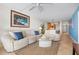 Inviting living room with comfortable seating, neutral tones, and easy access to dining area at 840 The Esplanade N # 104, Venice, FL 34285