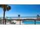 Community pool with ocean views and lounge seating, perfect for relaxing by the beach in a tropical setting at 840 The Esplanade N # 104, Venice, FL 34285