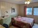 Comfortable bedroom featuring natural light, ceiling fan, and pleasant furnishings at 863 Baveno Dr, Venice, FL 34285