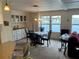 Elegant dining room with built-in cabinetry and serene water views from the large windows at 863 Baveno Dr, Venice, FL 34285