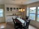 Dining room with water views, built-in cabinetry, and a dining table set for entertaining at 863 Baveno Dr, Venice, FL 34285