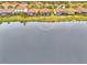 Aerial view of the property showing the location with a pond in the backyard and community at 9895 Wingood Dr, Venice, FL 34292