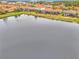 Aerial view of the property showing the location with a pond in the backyard and community at 9895 Wingood Dr, Venice, FL 34292